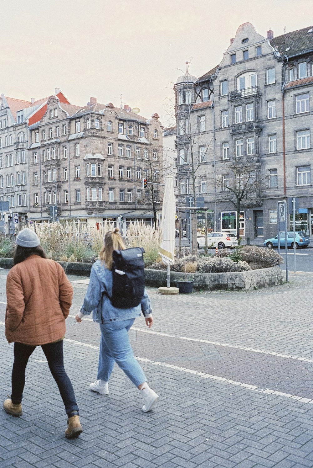 a couple of people walking down a street