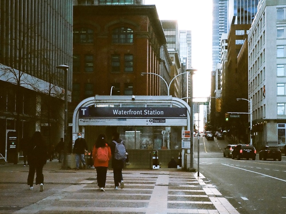 people crossing the street at a crosswalk in a city