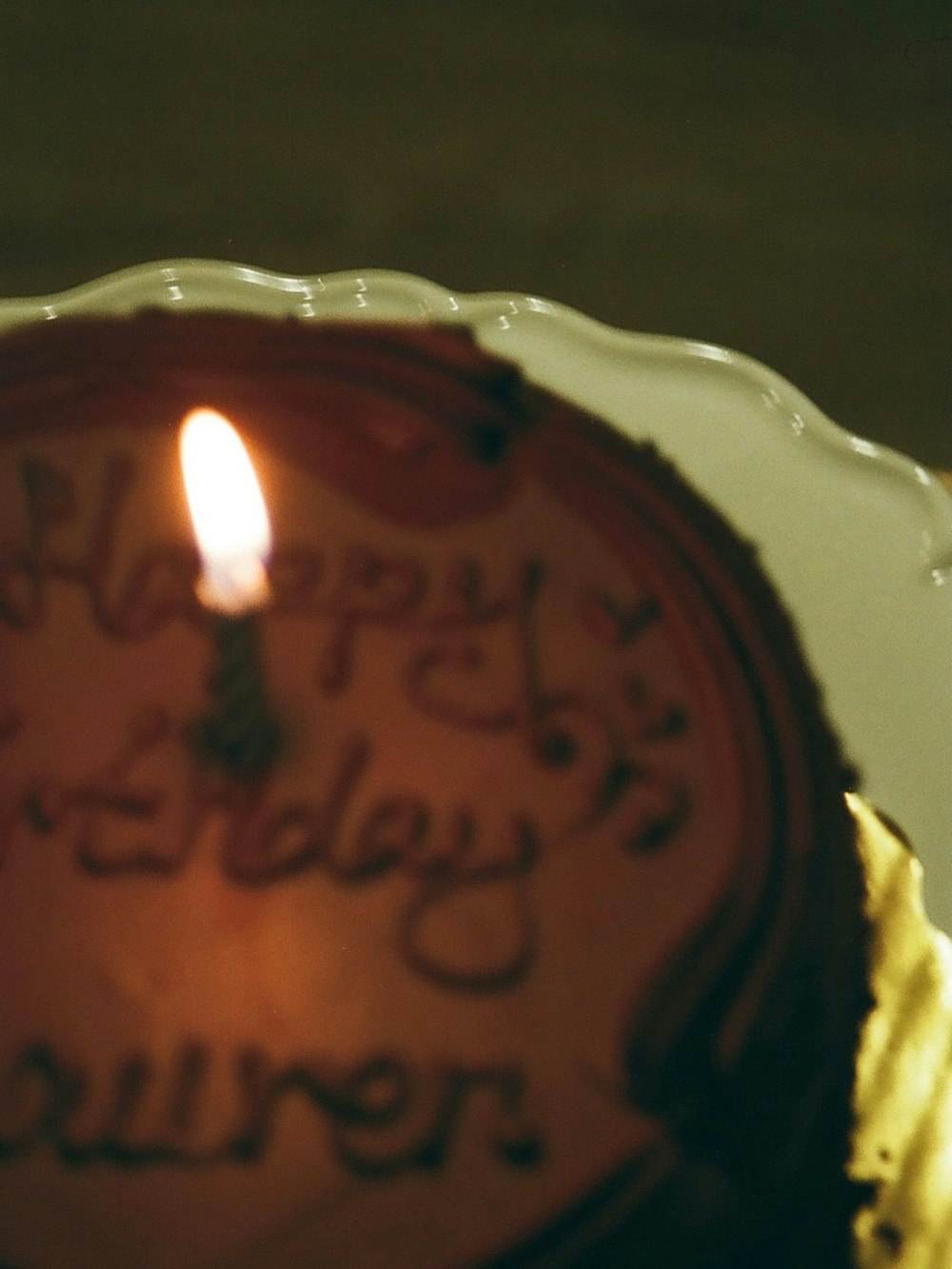 a birthday cake with a lit candle on it