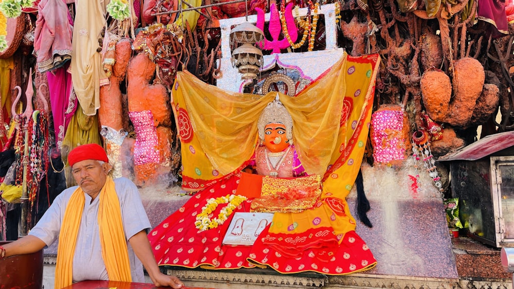 a man is sitting in front of a shrine