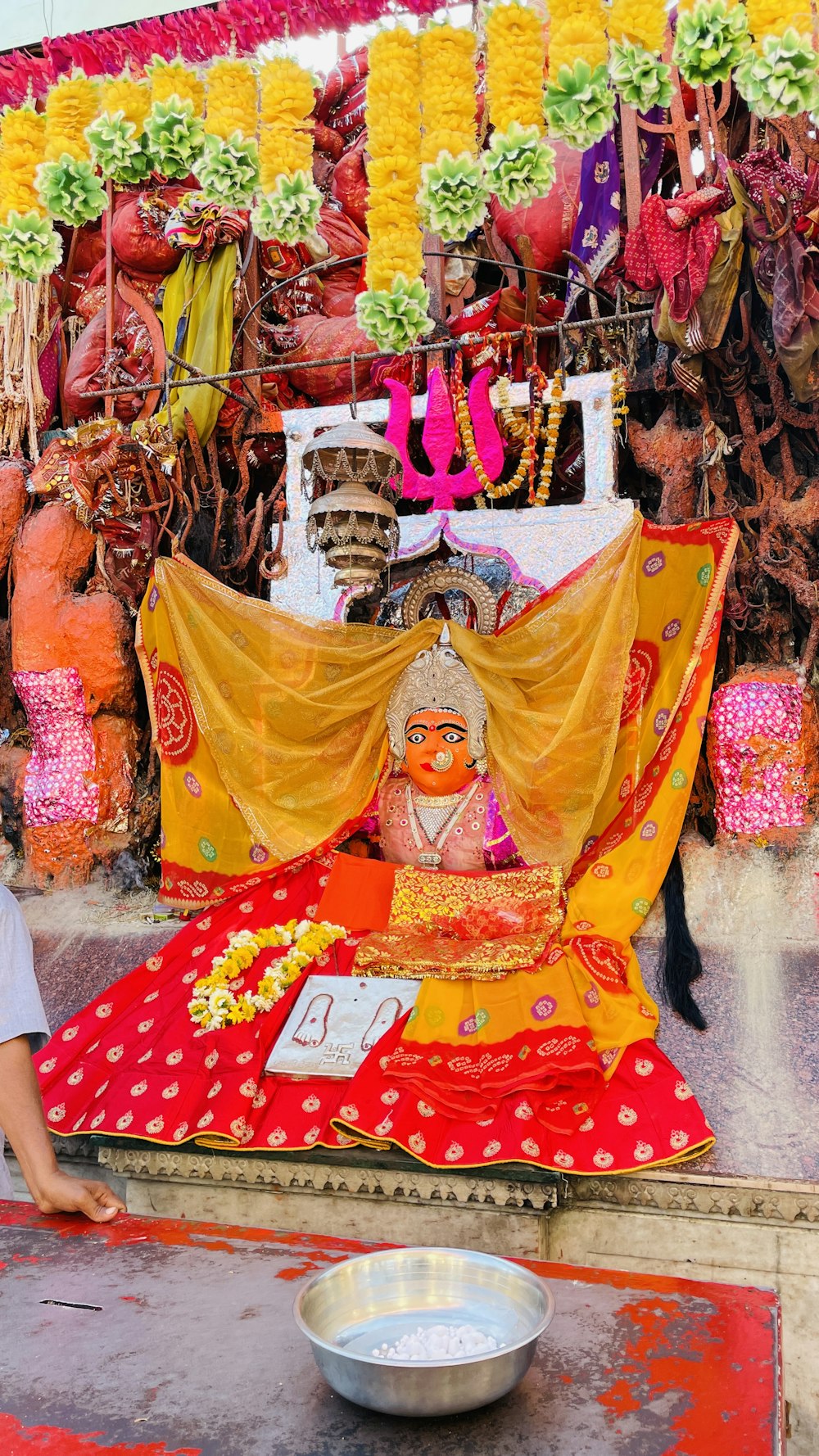 a man standing next to a statue in front of a store