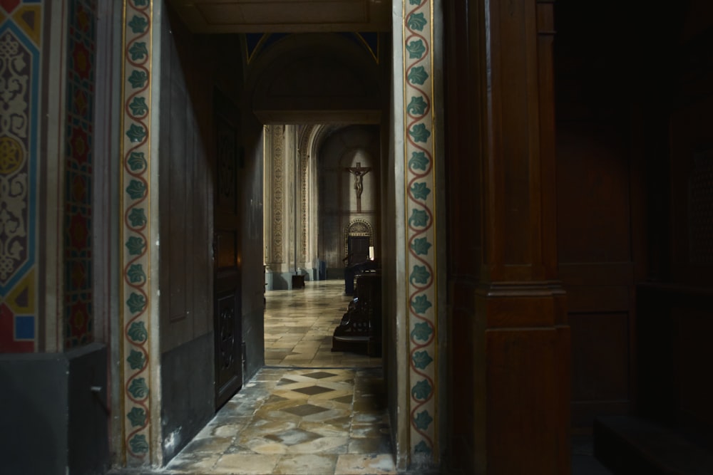 a hallway in a building with a tiled floor