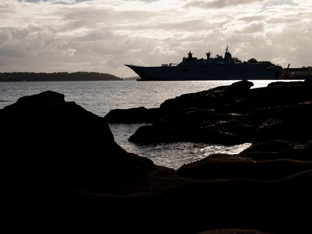 a large ship is in the distance on the water