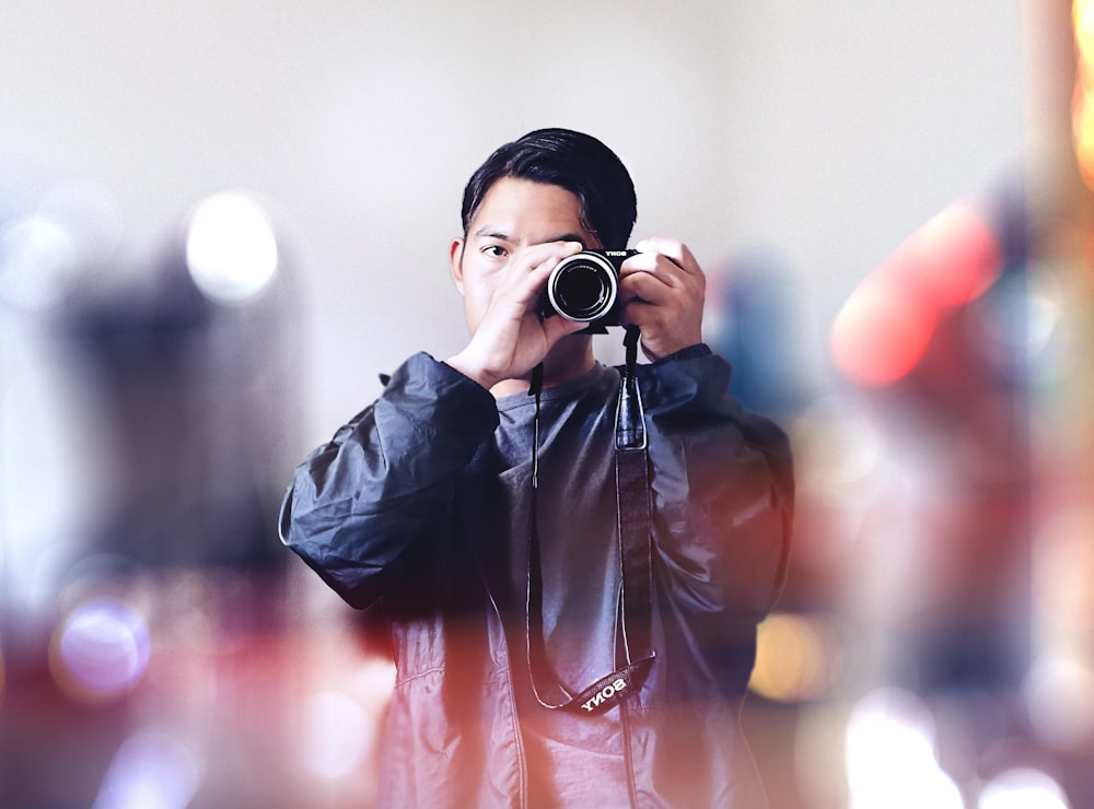 a man taking a picture of himself with a camera