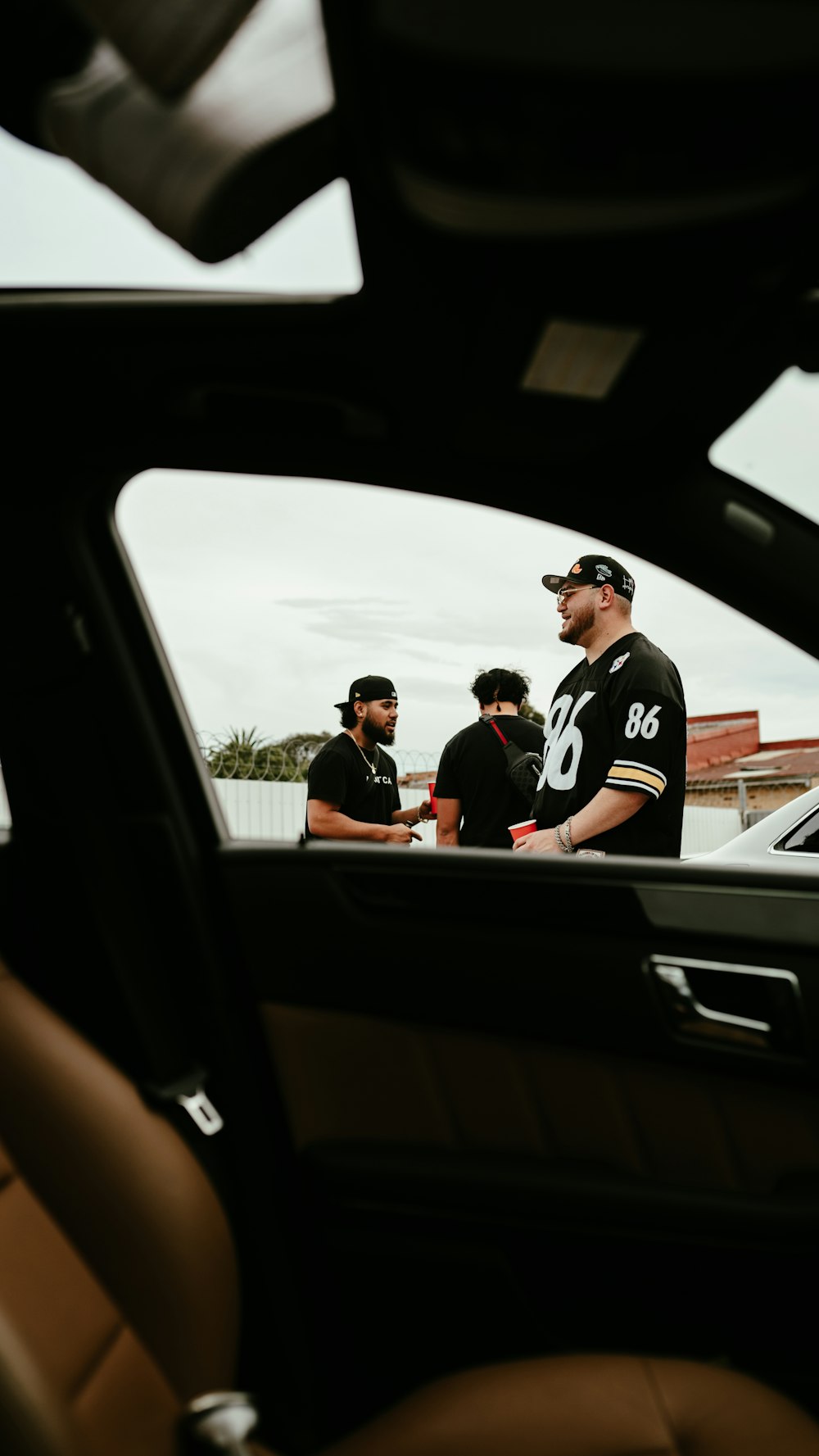 a group of men standing next to each other in a car