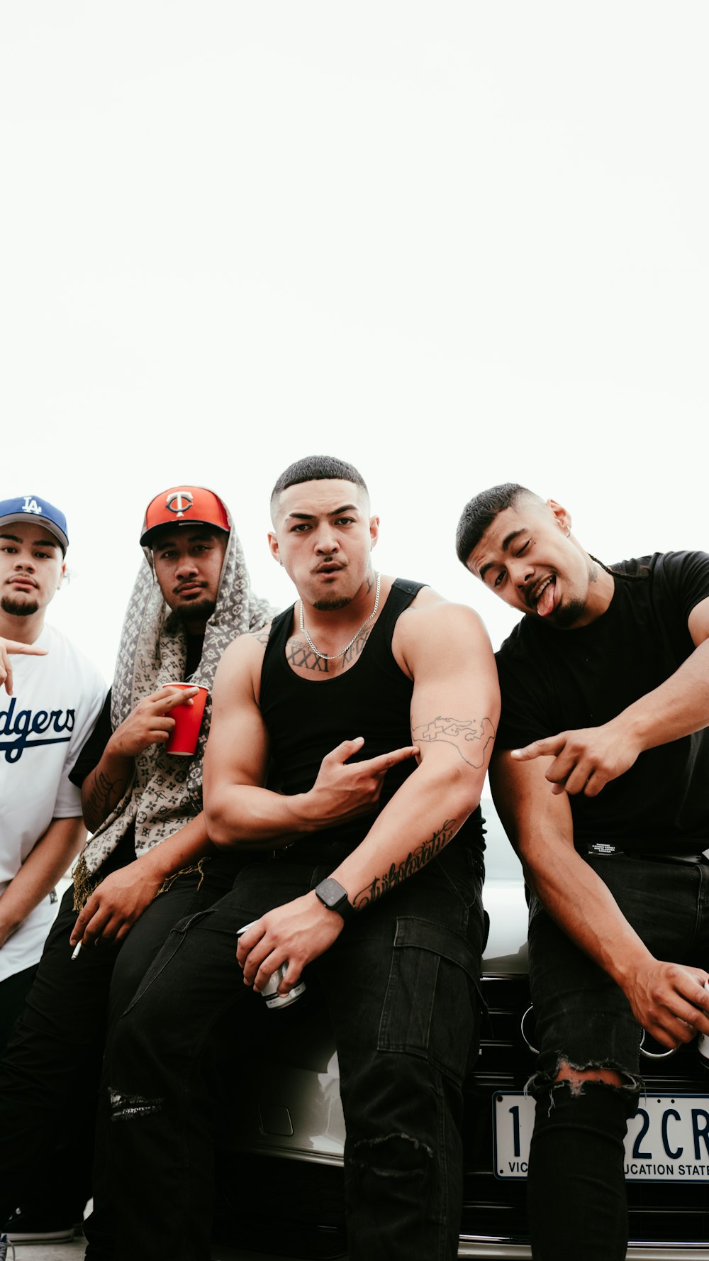 a group of men sitting on the back of a truck