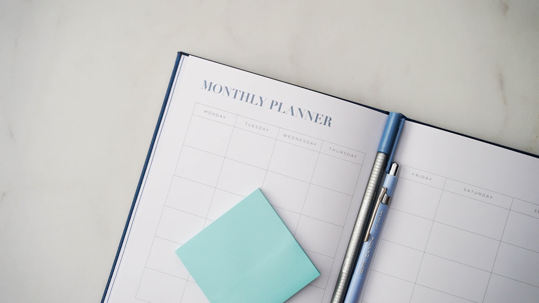 a planner with a pen on top of it,
