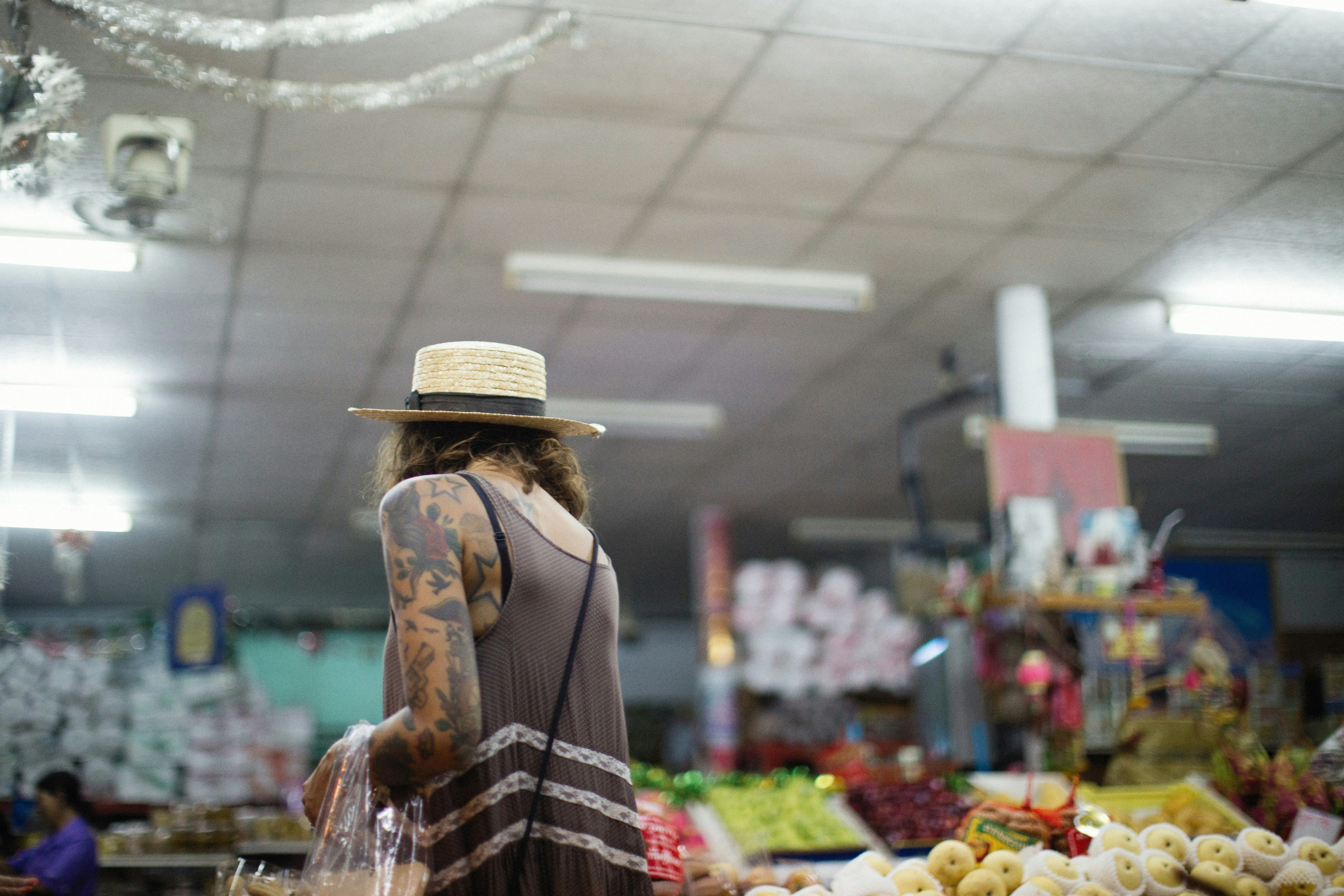 a person with a hat standing in a store