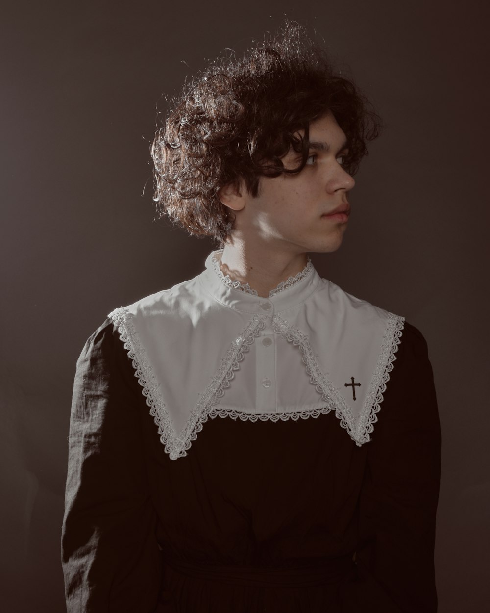 a woman with curly hair wearing a black and white shirt