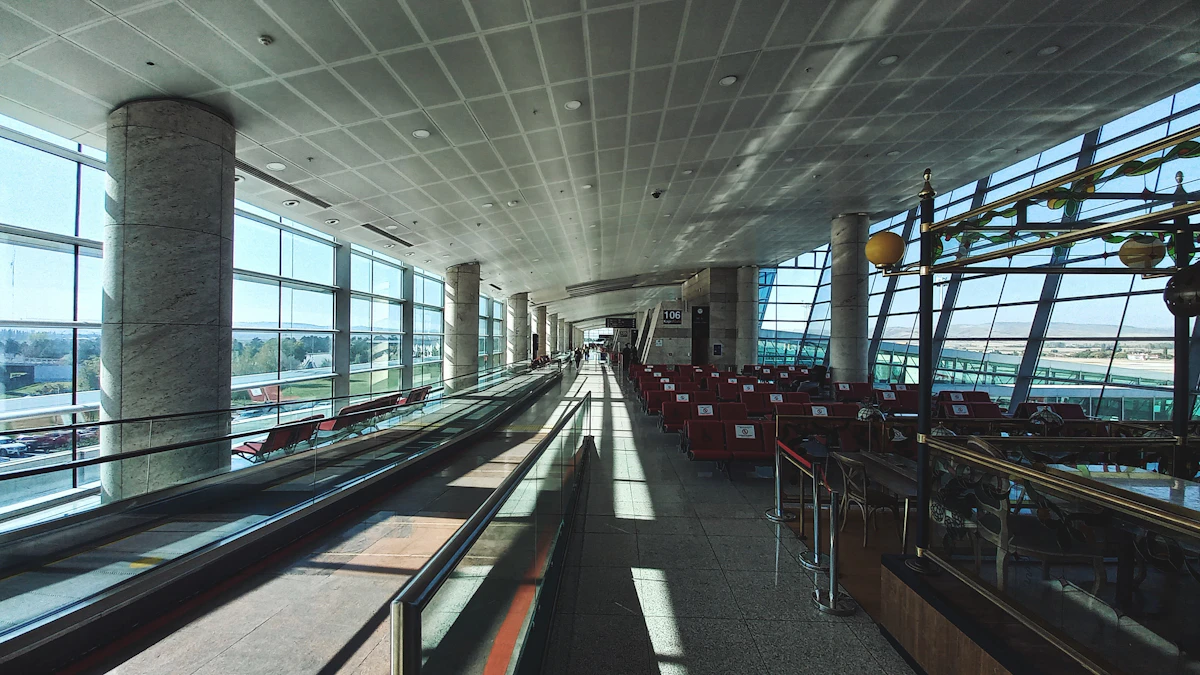 Long airport concourse lined with tall windows