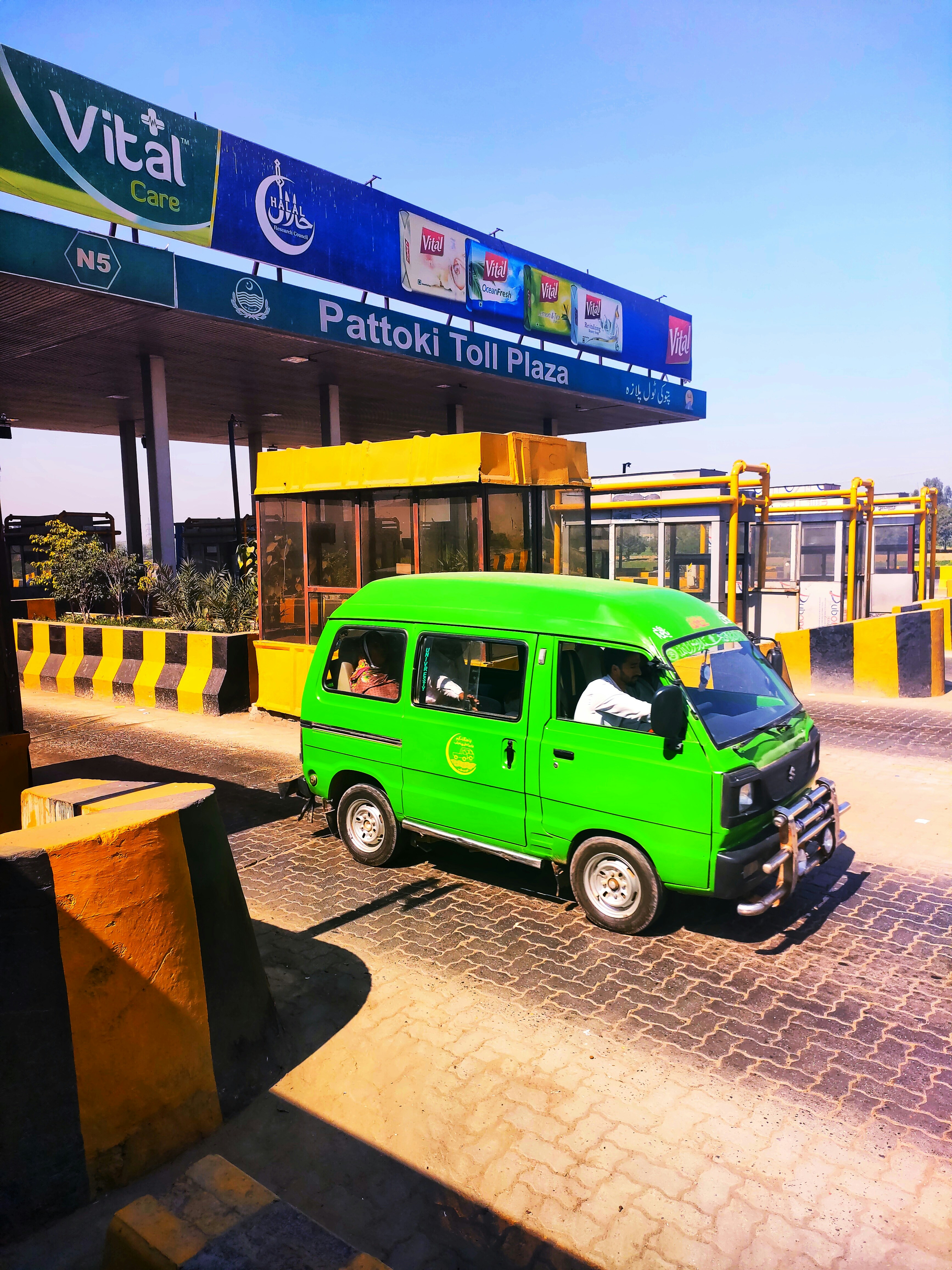 a green van parked in front of a gas station