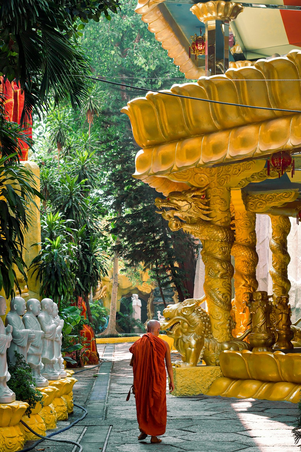 a monk walking down a path in a temple