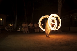 a man is spinning a fire ring around his body