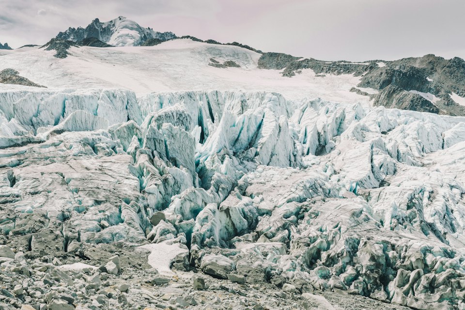 A large glacier winding between mountains near Chamonix