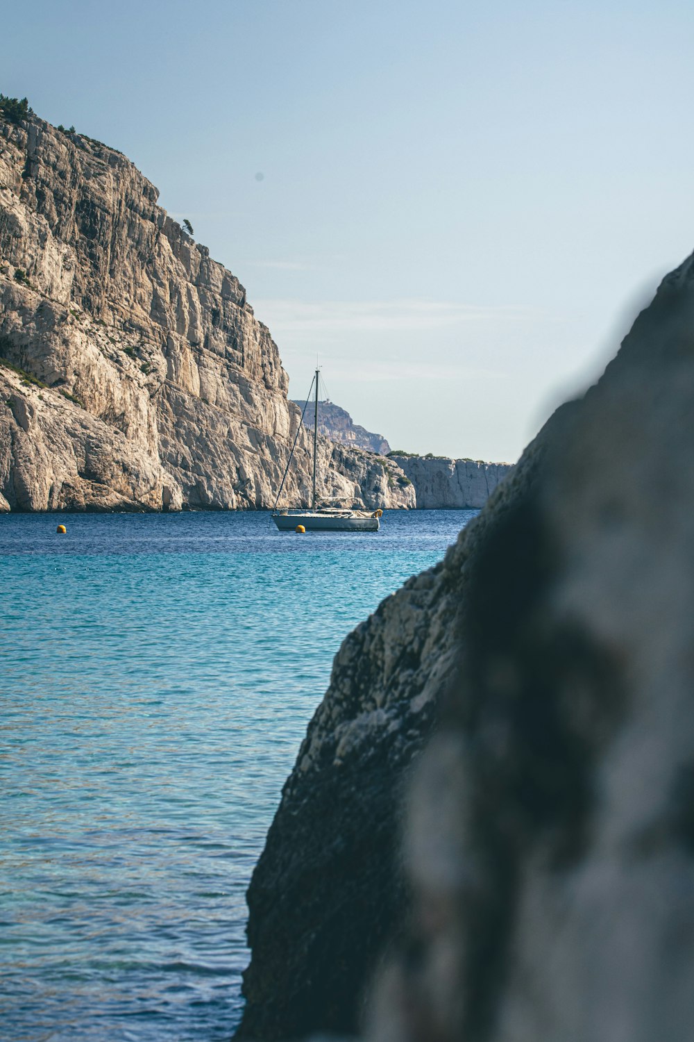 a large body of water with a mountain in the background