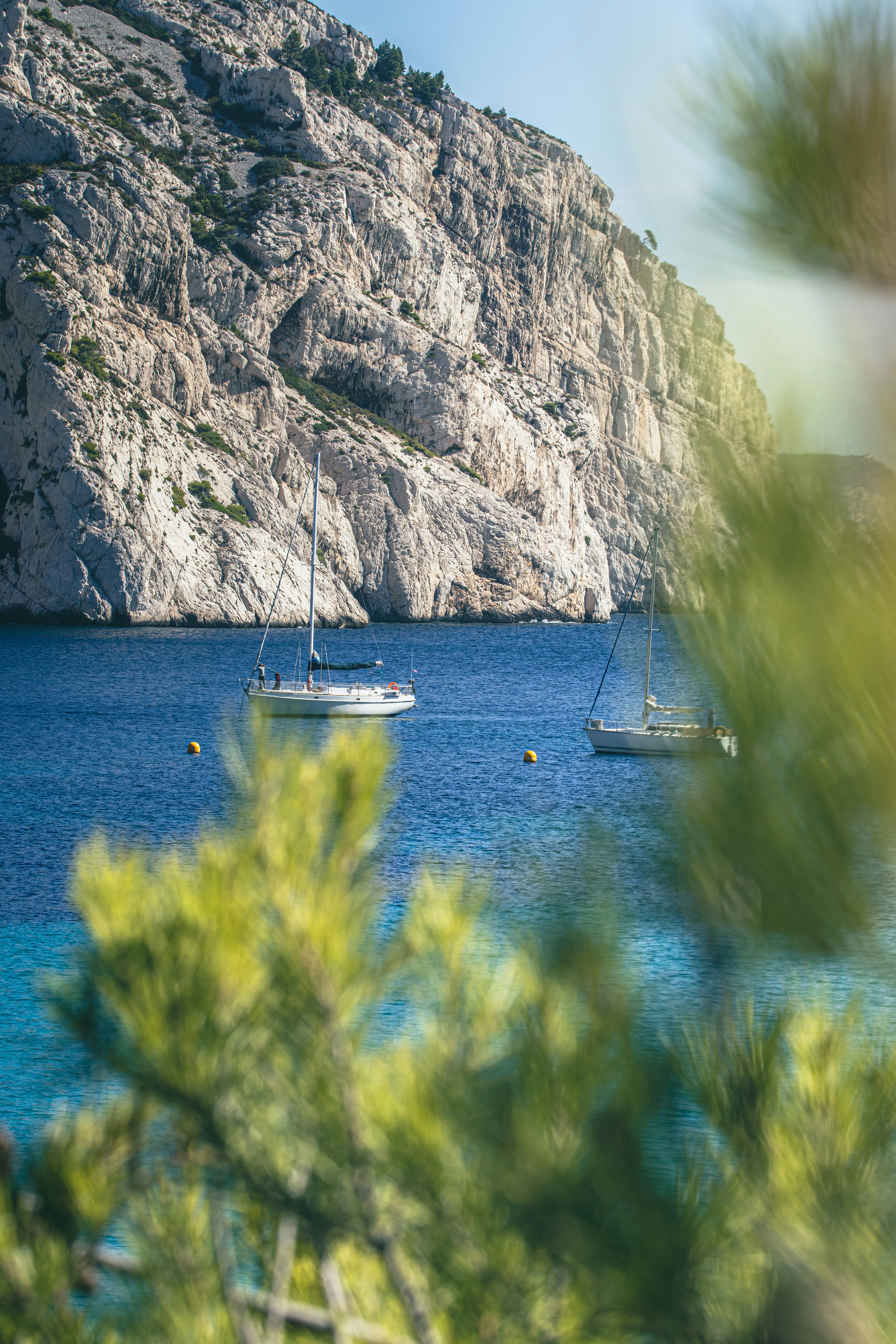 a couple of boats floating on top of a body of water