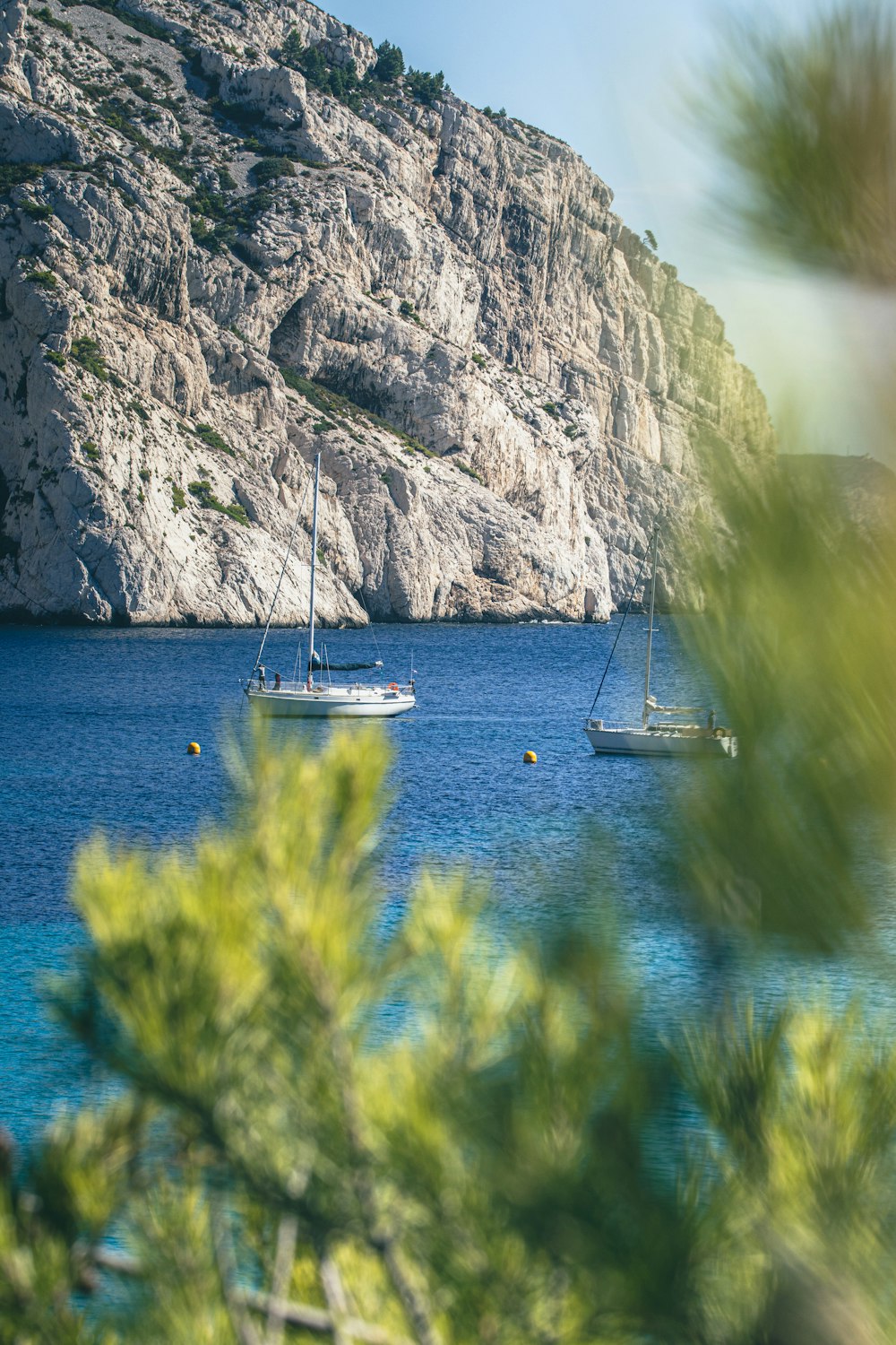 a couple of boats floating on top of a body of water