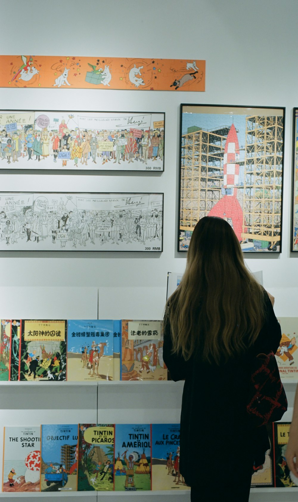 a woman looking at a display of children's books