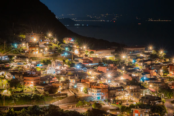 Evening shot of the villa community nestled in the hills with soft lights glowing warmly.