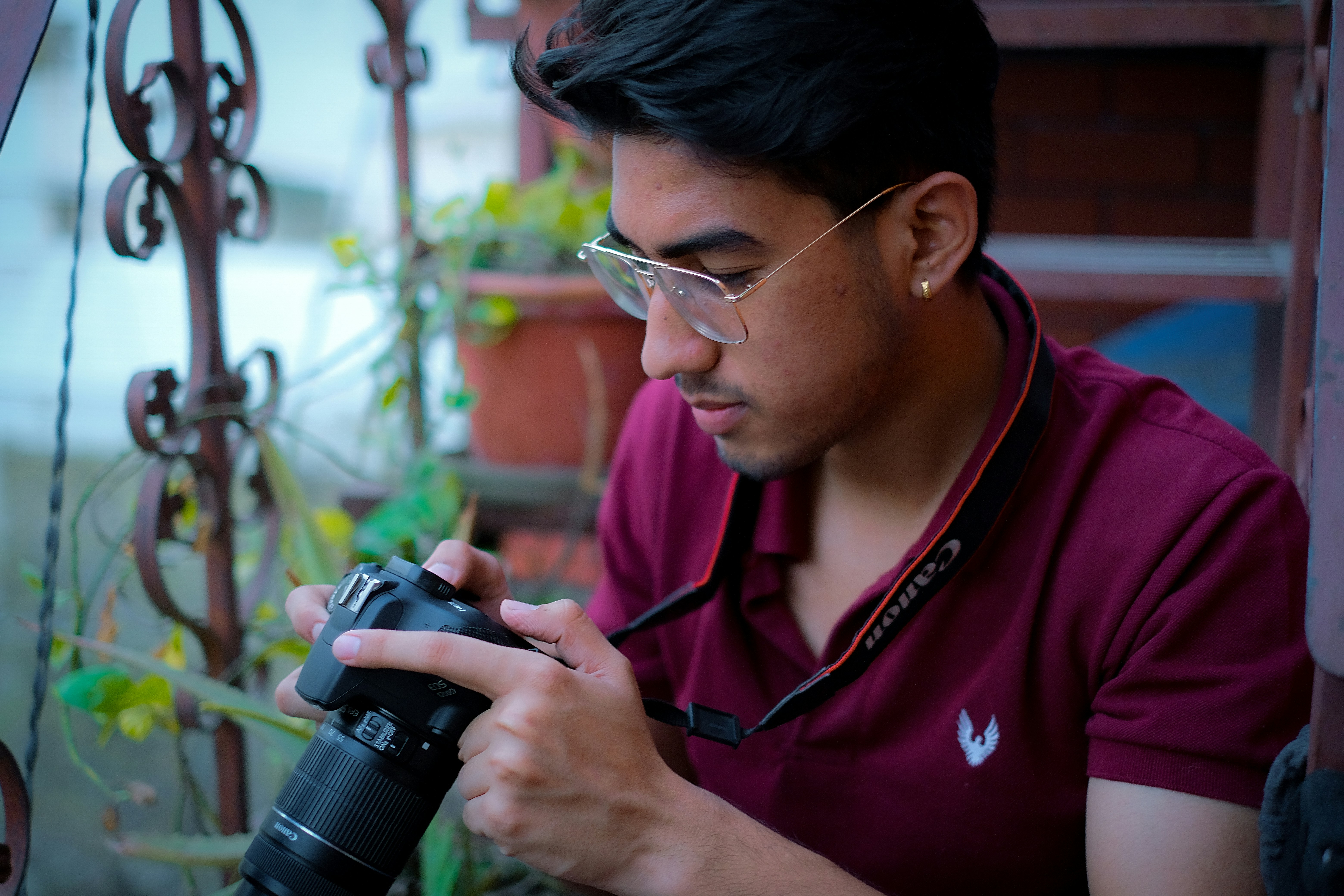 a man in a red shirt holding a camera