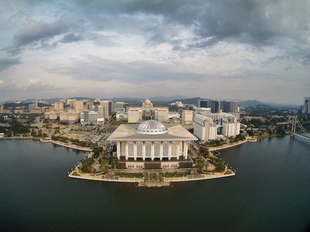 an aerial view of a city with a lake in front of it