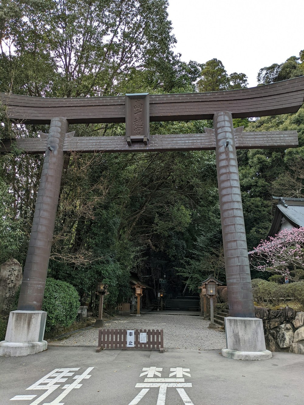 a large wooden gate with a bench in front of it