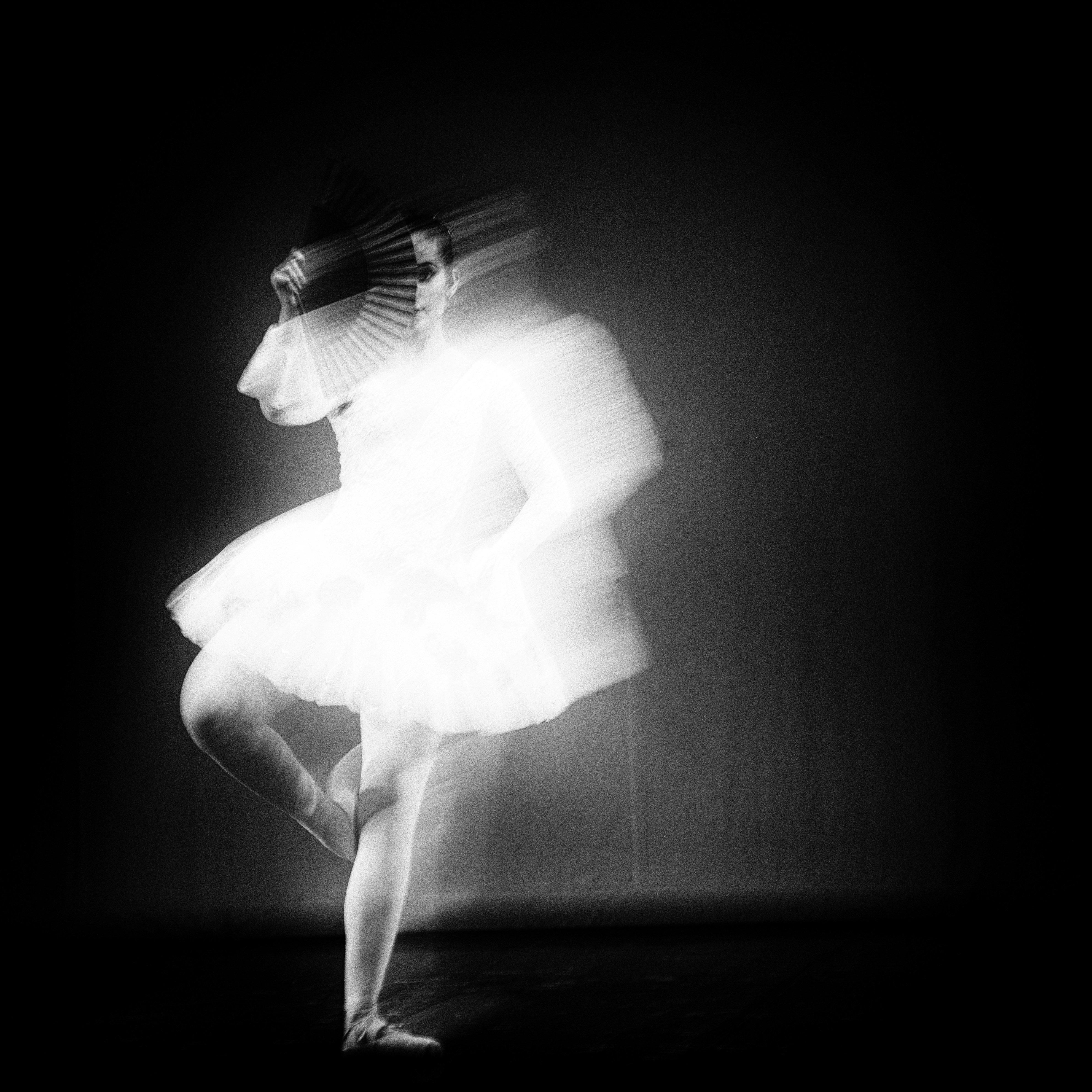 a black and white photo of a ballerina
