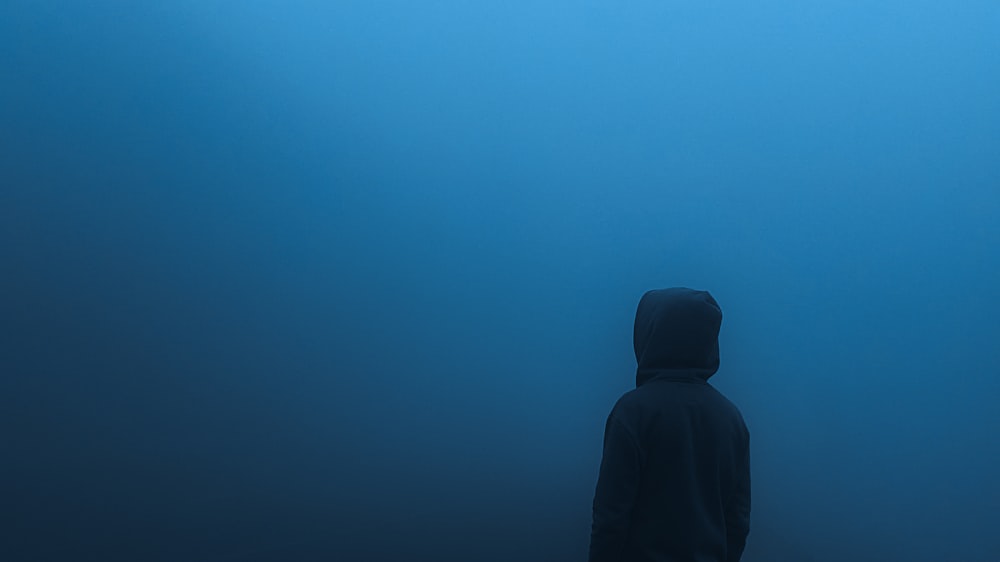 a person standing in the middle of a blue ocean