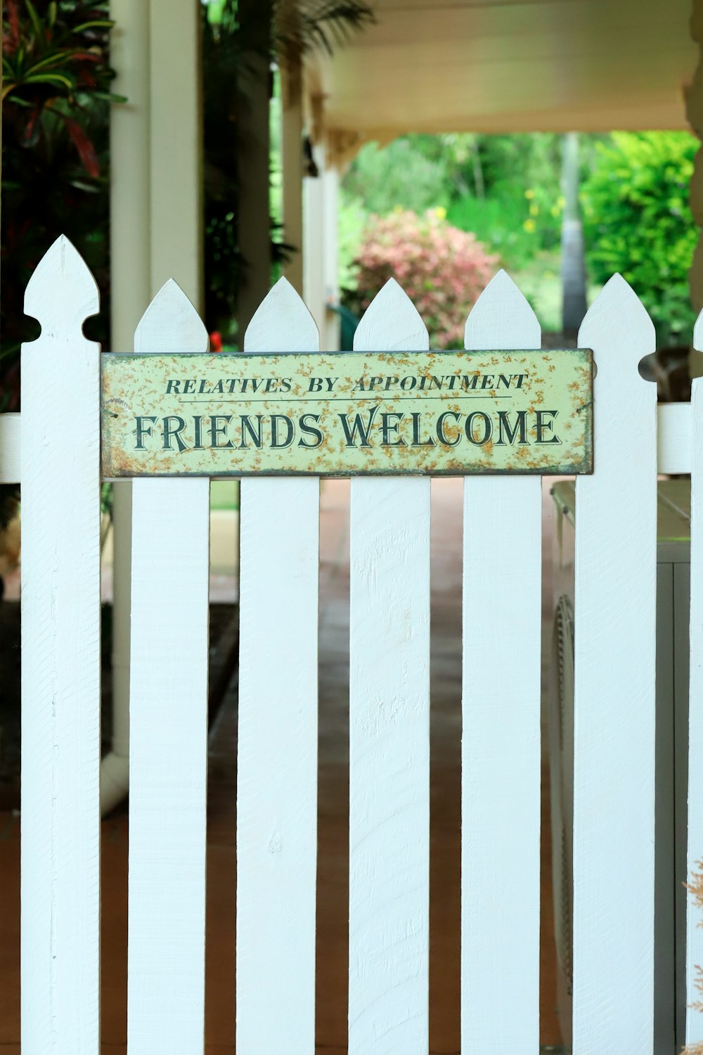 a white picket fence with a sign on it