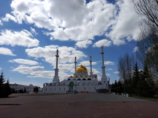 A serene landscape of a mosque under a clear blue sky.