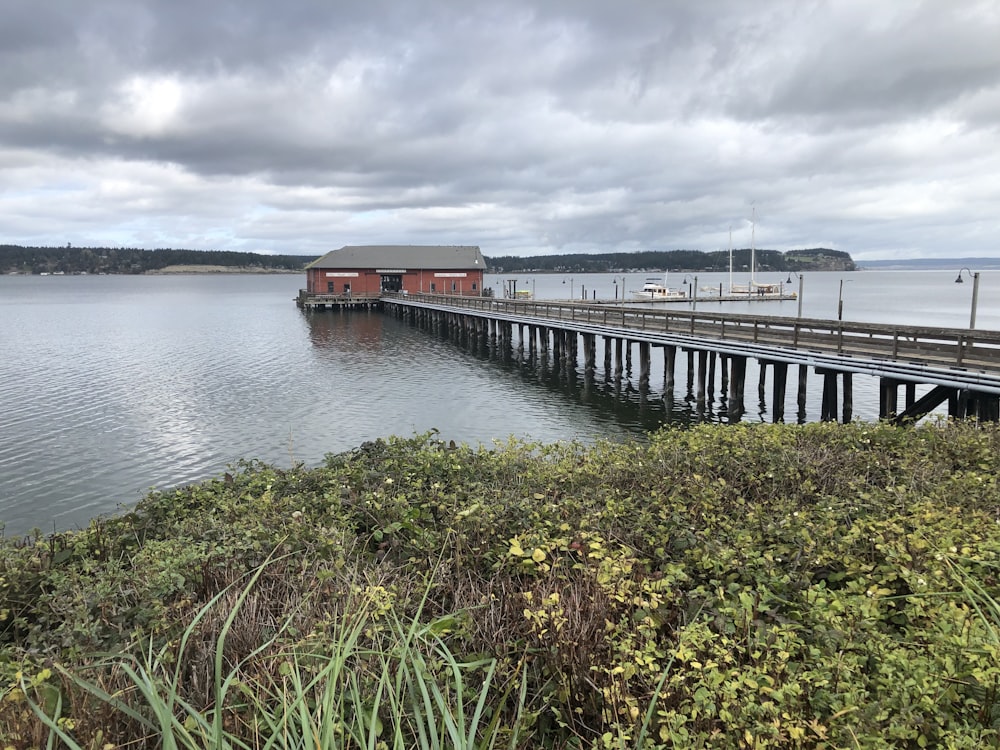 a long dock with a house on top of it