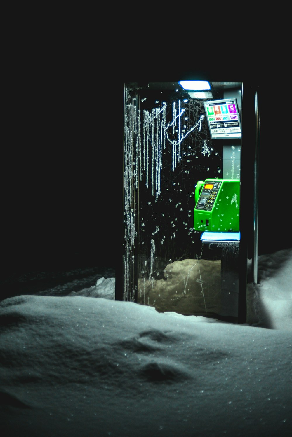 a vending machine sitting in the middle of a snow covered field