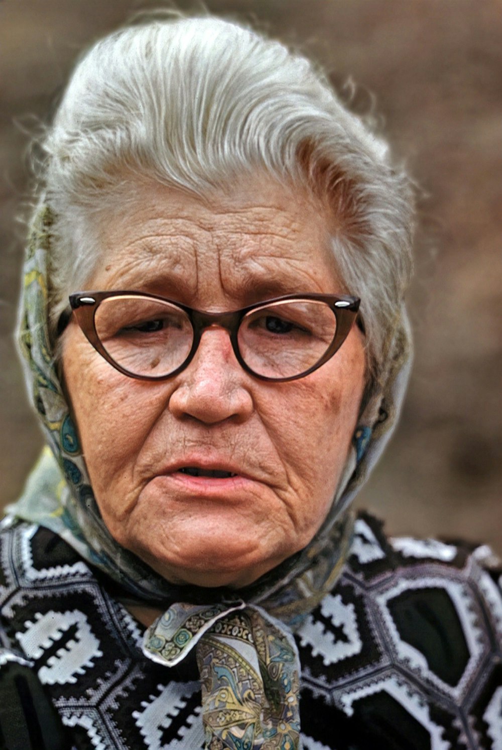 a close up of a man wearing glasses