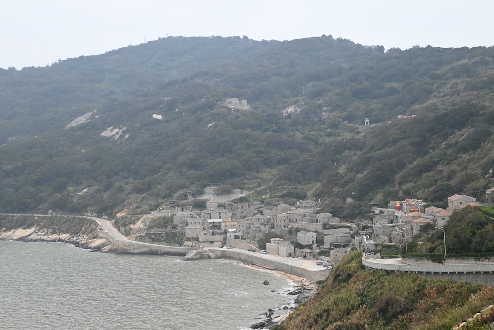 a scenic view of a town on the side of a mountain