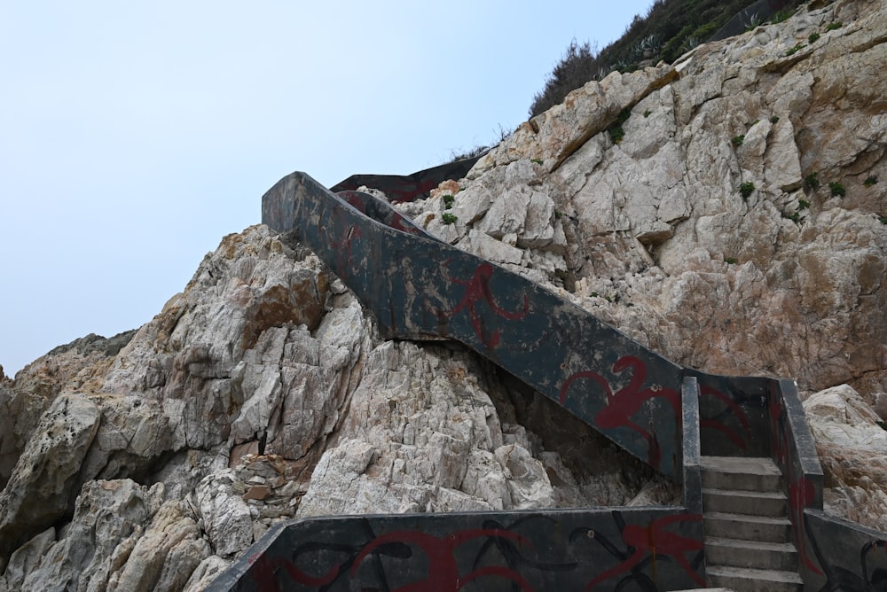 a skateboarder is going down a ramp on a mountain