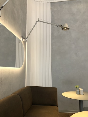 a corner of a room with a couch and a table