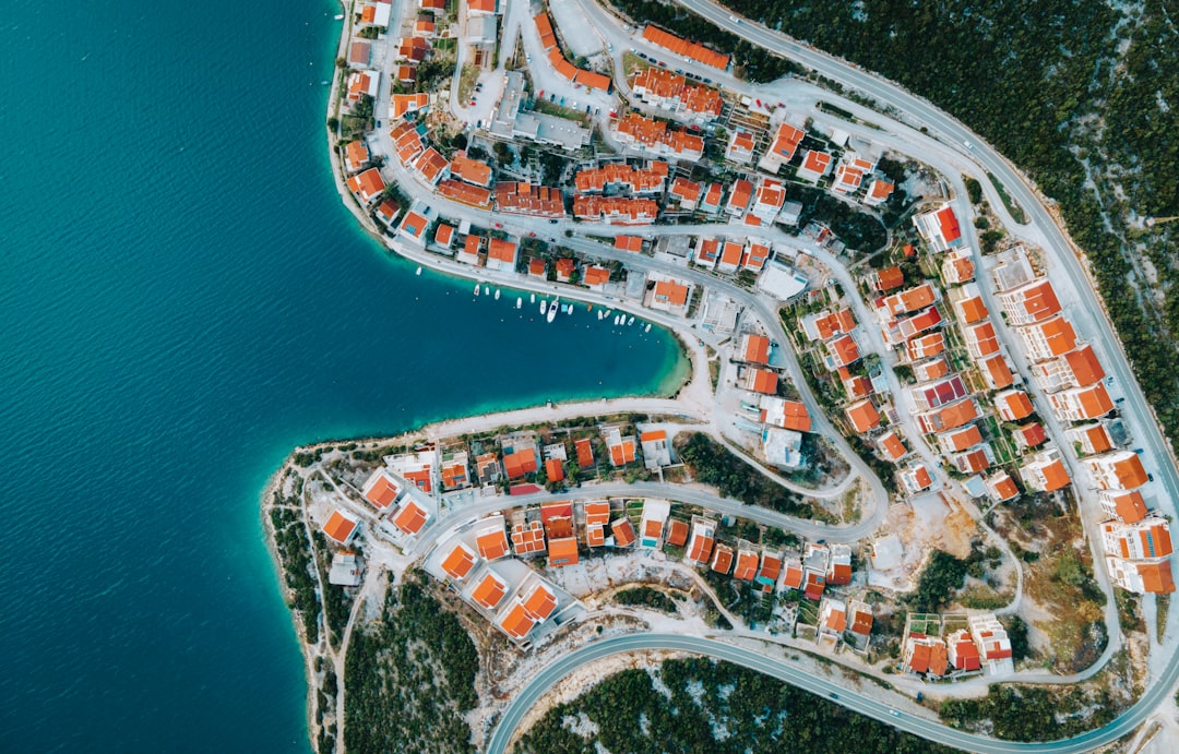 an aerial view of a city by the water,
