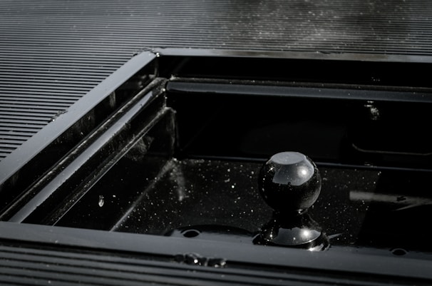 Detailed shot of a custom-made coifa with smooth matte black finish and precise edges