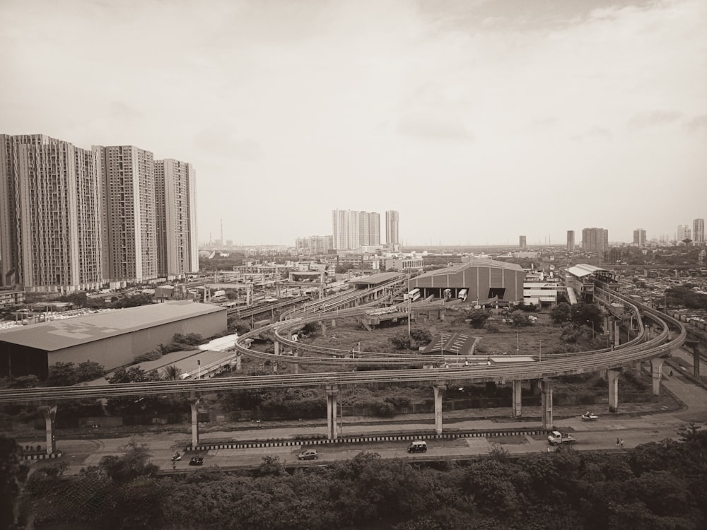 a black and white photo of a highway in a city