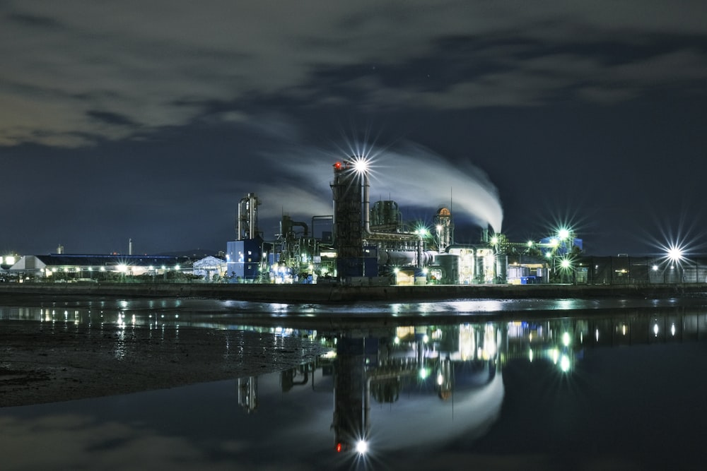 a large industrial plant is lit up at night