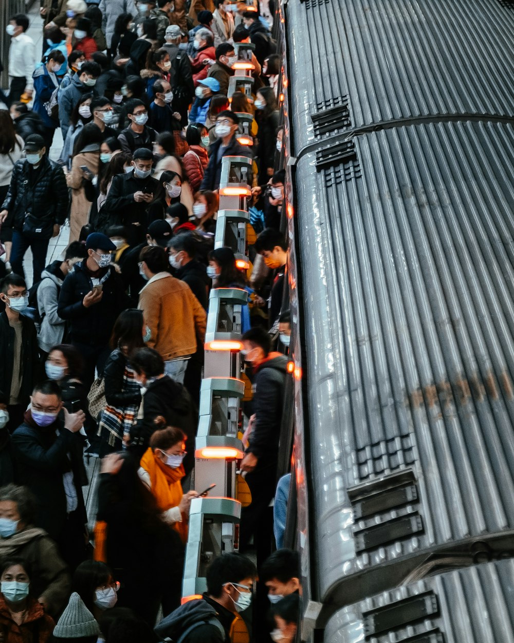 a crowd of people standing next to a train