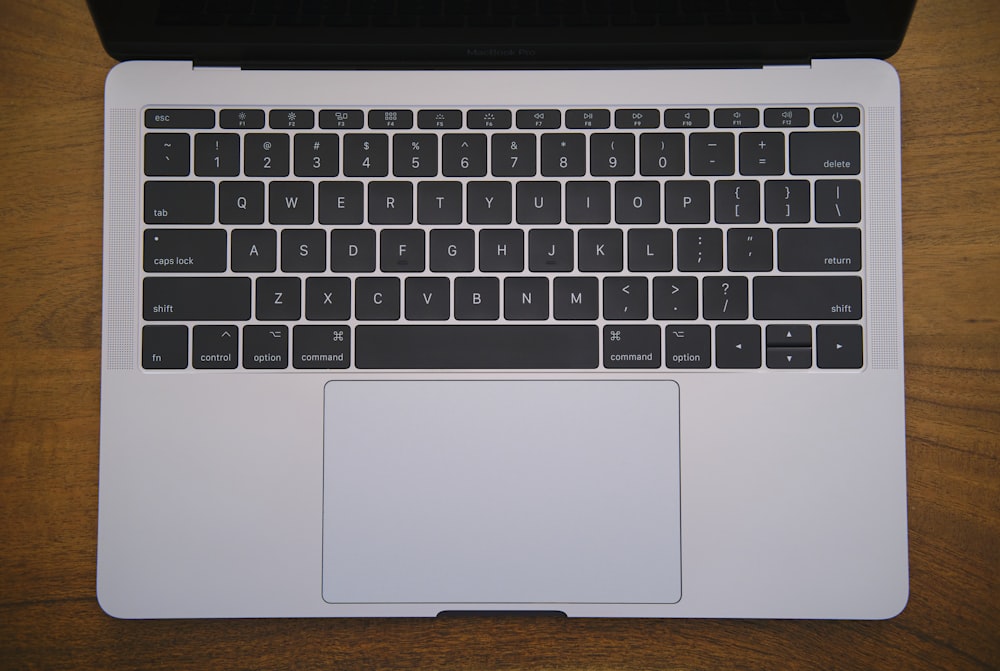 a laptop computer sitting on top of a wooden table