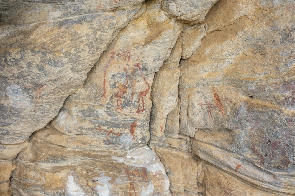 a close up of a rock wall with some writing on it