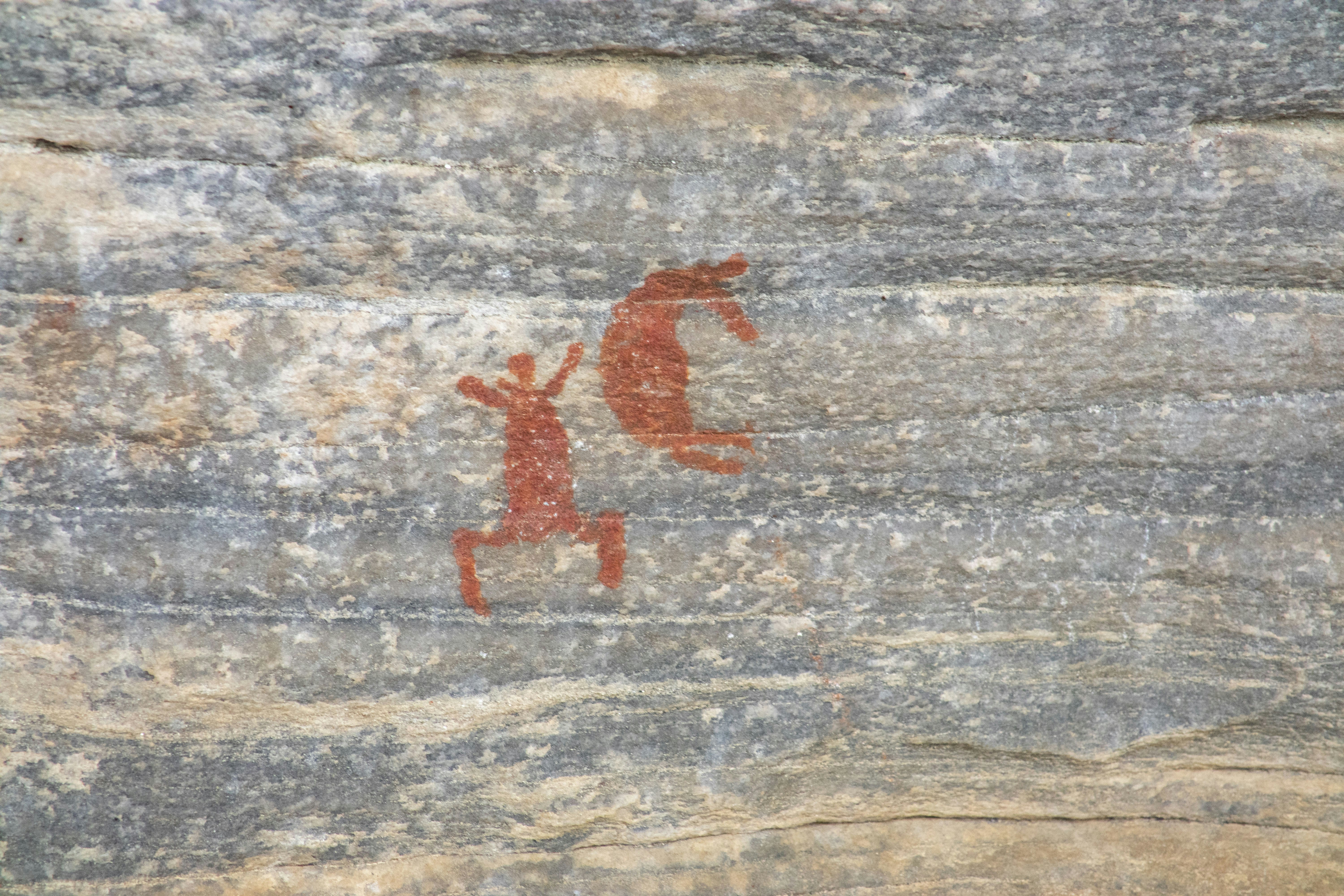 a rock with a picture of a man and a horse on it, Indigenous people cave paintings from the Xique Xique Archeological site at Carnaúba dos Dantas, Rio Grande do Norte, Brazil