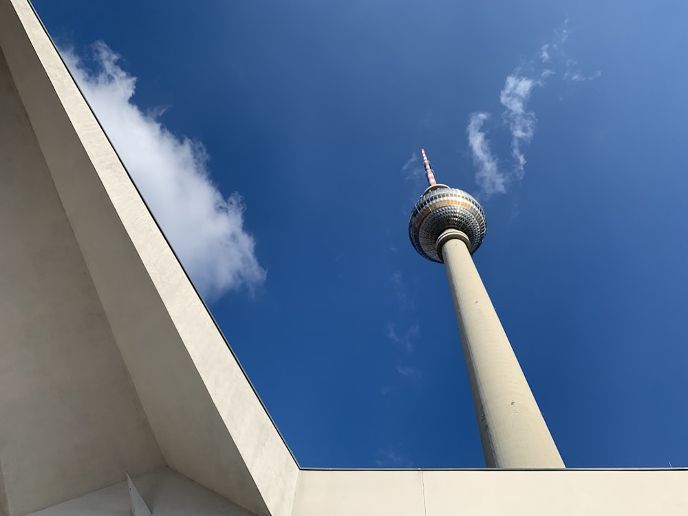 a tall white building with a sky background