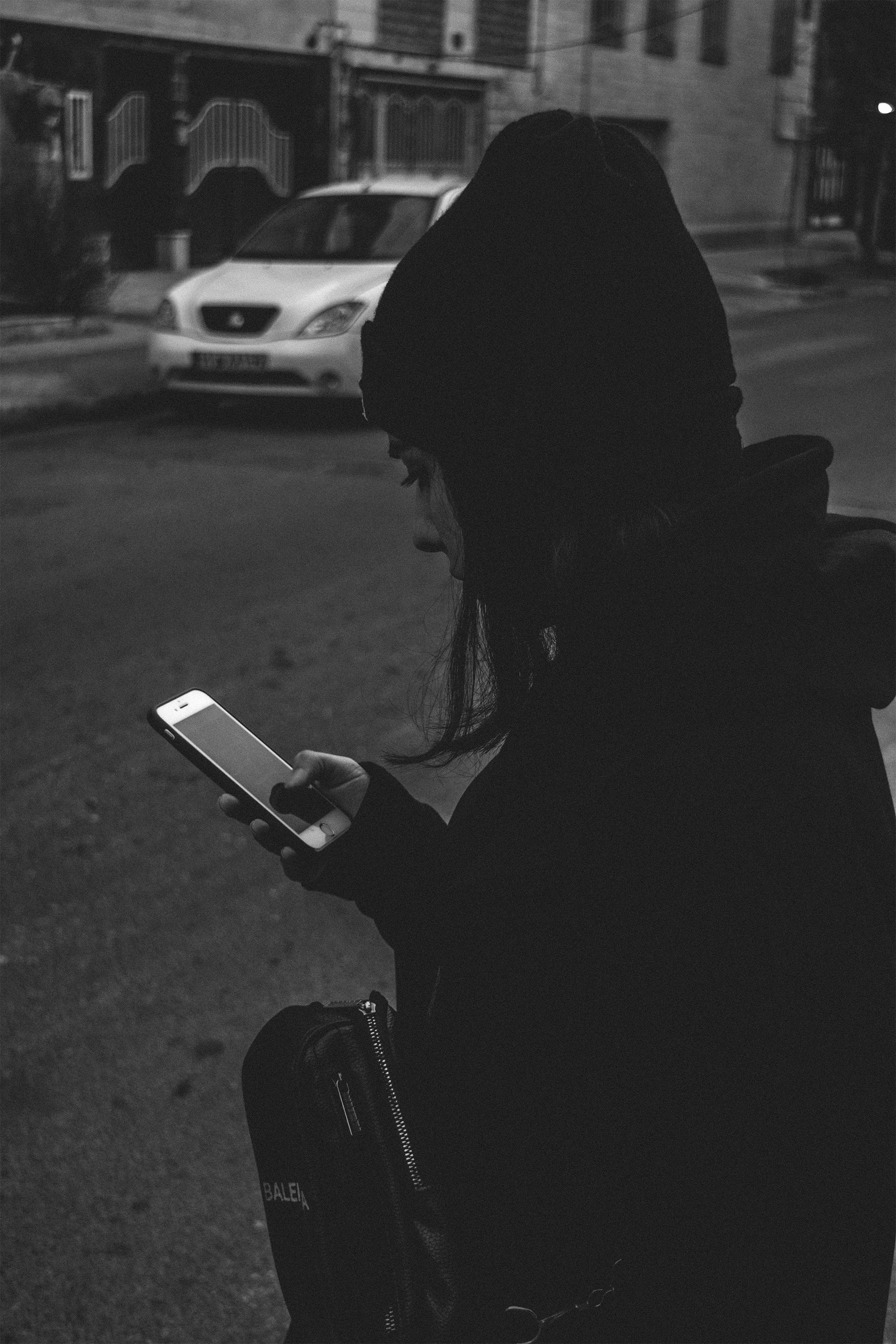 a person sitting on a bench looking at a tablet