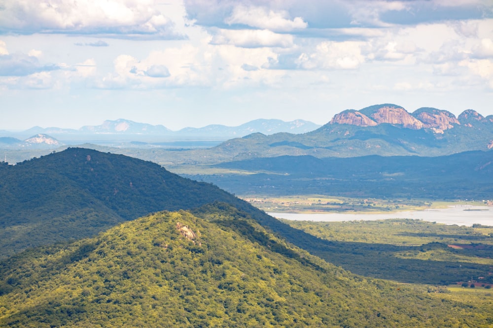 a scenic view of a mountain range with a lake in the foreground