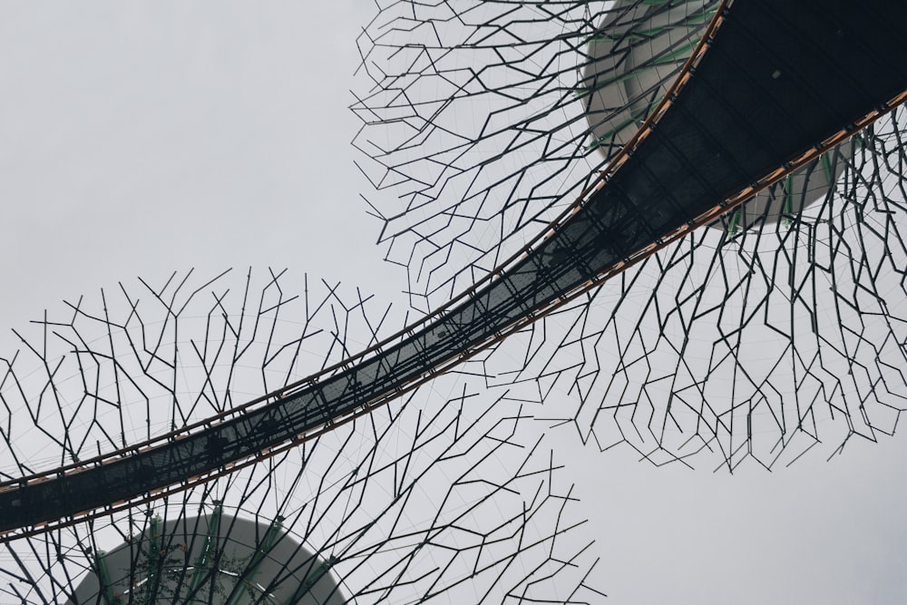 a close up of a metal structure with a sky background