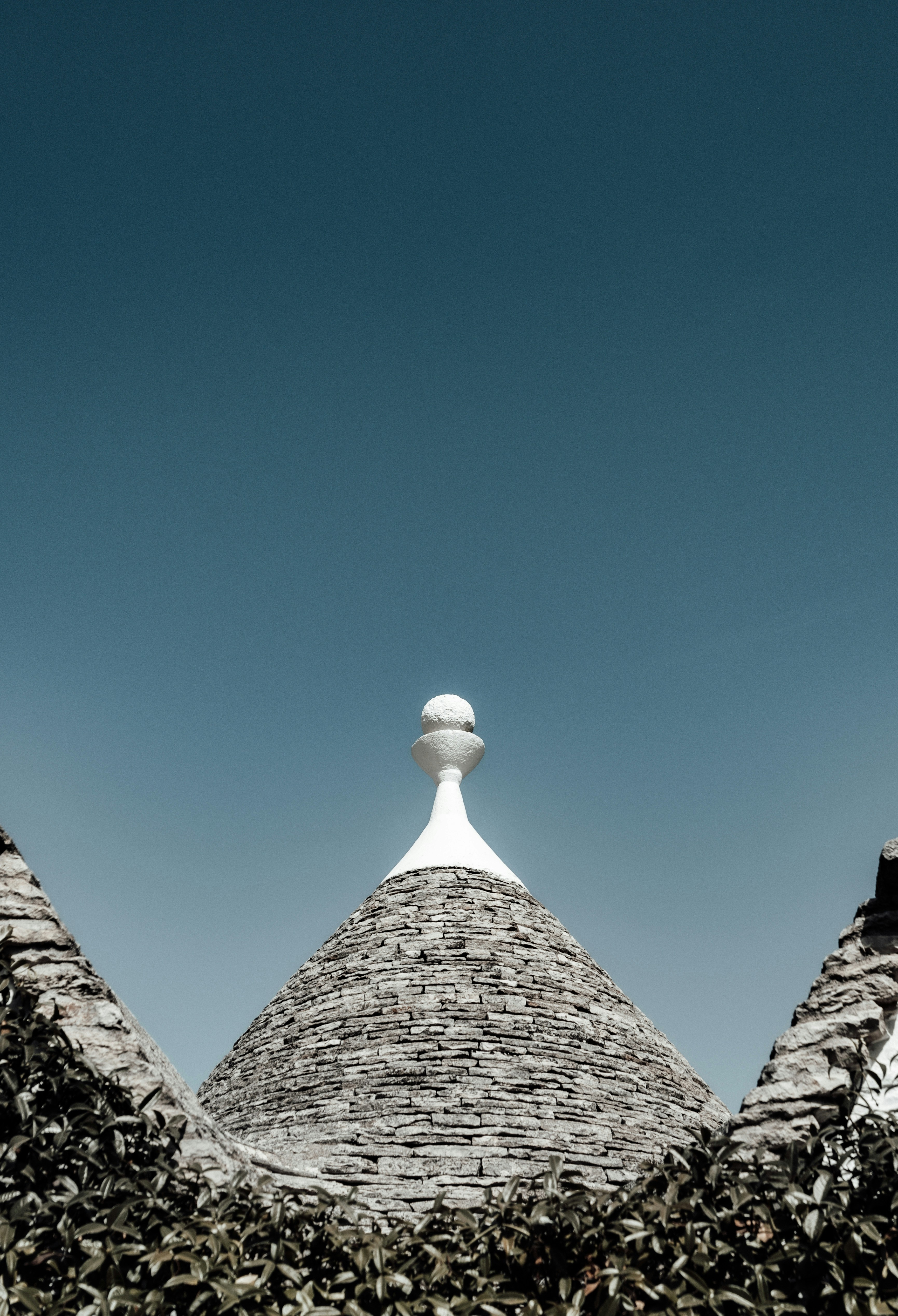un edificio in pietra con un tetto bianco e un camino bianco