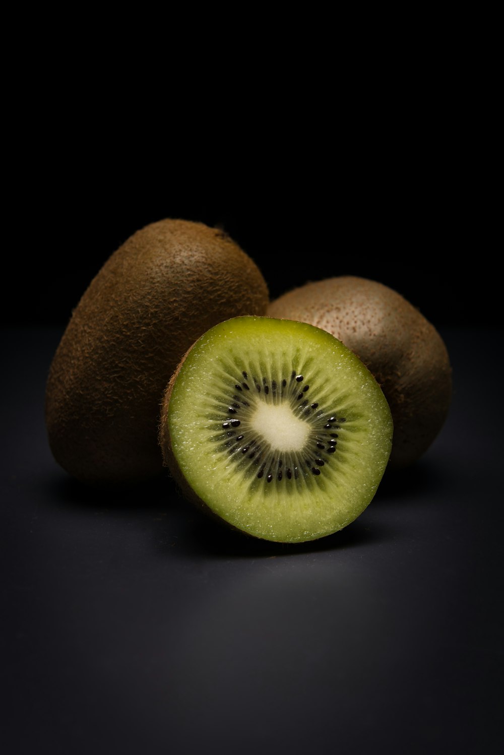 a kiwi cut in half sitting on a table